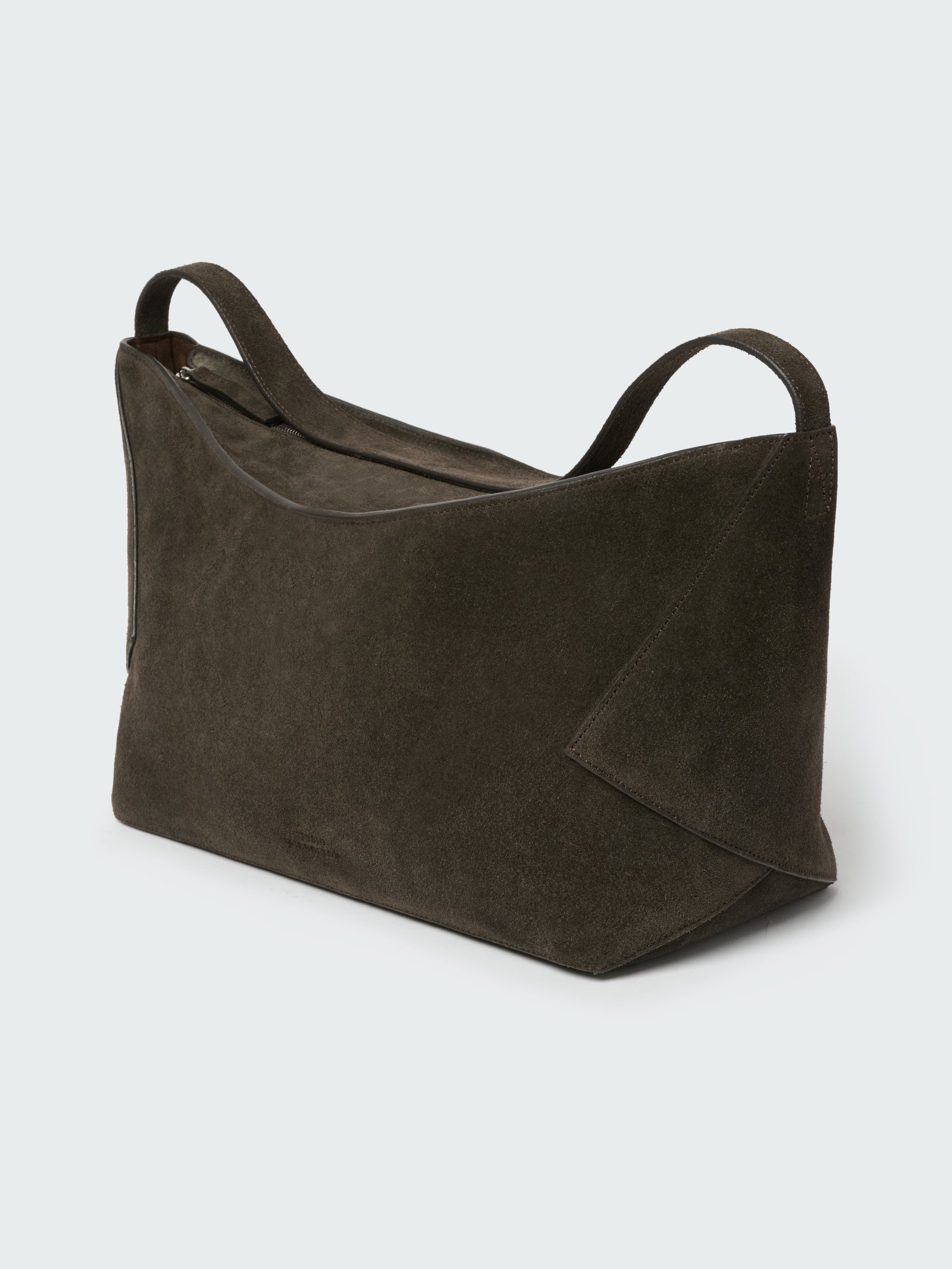 Brown leather bag on a light gray background